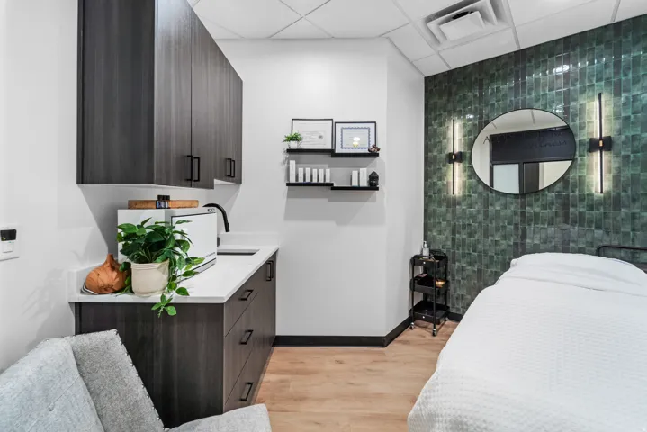 Bedroom with a drop ceiling and light wood-style flooring