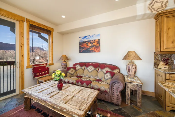 Living area featuring stone tile flooring, a mountain view, and recessed lighting