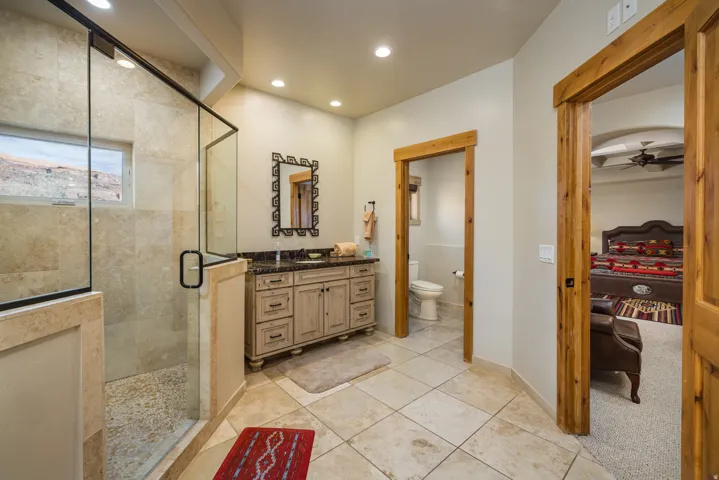 Bathroom with vanity, a stall shower, light tile patterned flooring, recessed lighting, and a ceiling fan