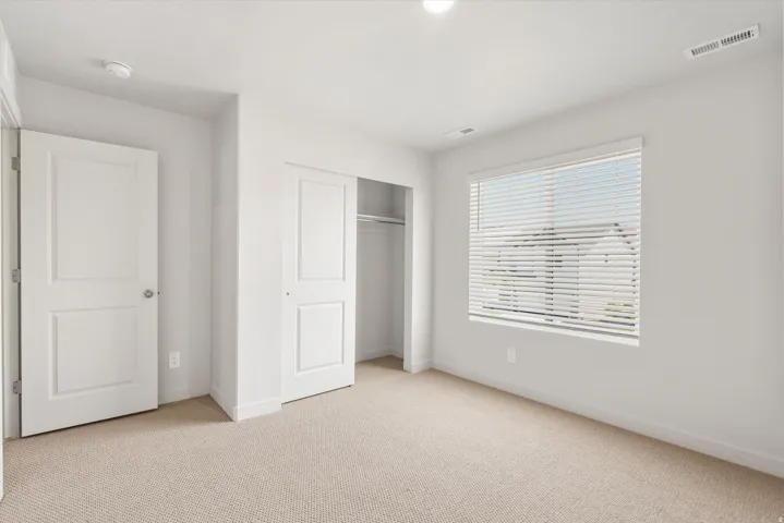 **DISLCAIMER** Exterior & Interior packages may vary.Unfurnished bedroom with carpet flooring and a closet