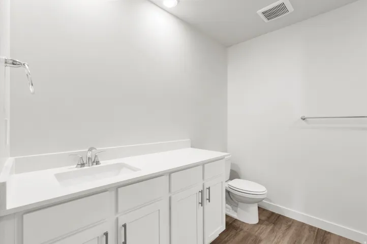 **DISLCAIMER** Exterior & Interior packages may vary.Half bath with vanity and dark wood finished floors