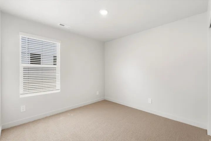 **DISLCAIMER** Exterior & Interior packages may vary.Spare room featuring baseboards and carpet flooring
