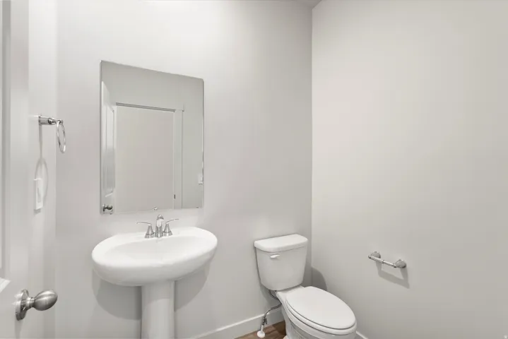Bathroom featuring toilet and baseboards