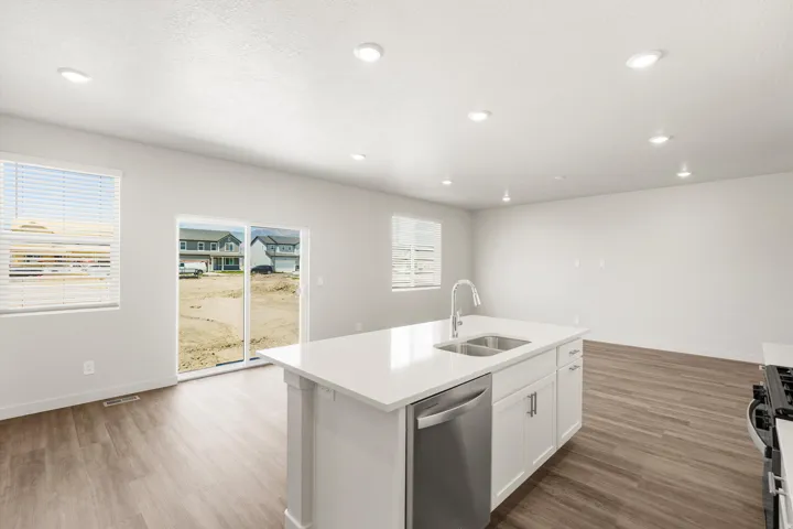 **DISLCAIMER** Exterior & Interior packages may vary.Kitchen featuring dishwasher, white cabinets, light wood finished floors, gas range oven, and recessed lighting