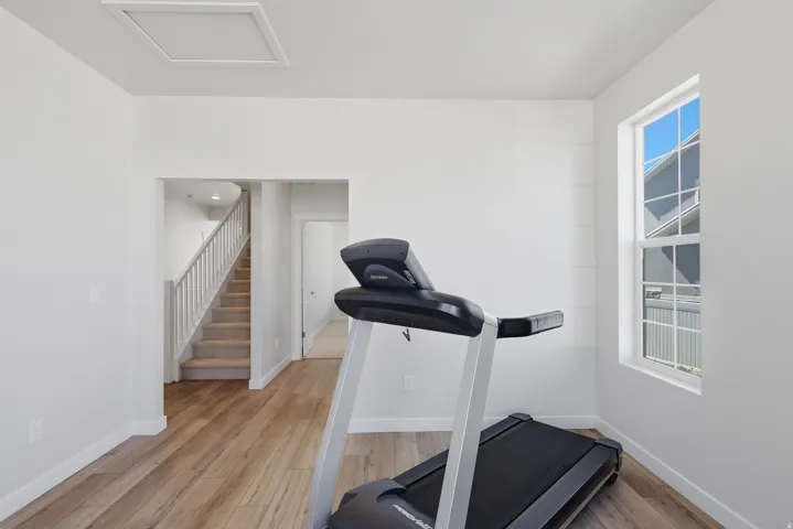View 2 showing Entry and Stairs.  Office, living room, workout room with light wood-style floors and baseboards