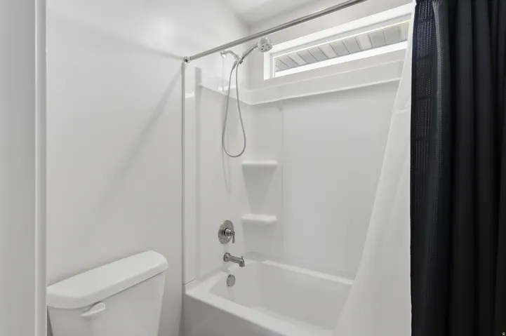 View 2 Full bathroom featuring shower / tub combo with curtain and toilet