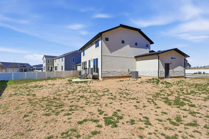 View of home's exterior featuring stone siding, stucco siding, and entry steps