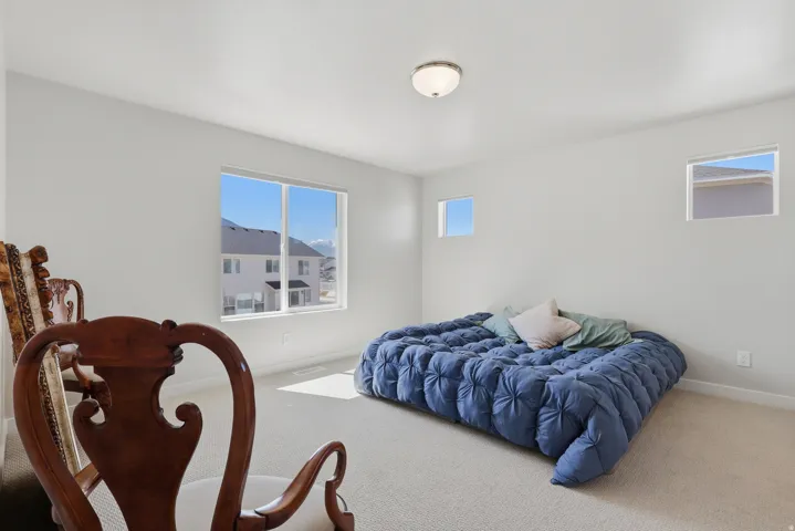 Primary Bedroom with carpet and baseboards