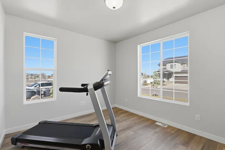 This can be an office, living room, workout room featuring light wood-type flooring and healthy amount of natural light.  Right off of the entry.