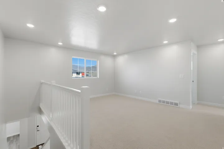 Vie w2 Loft Family Room with recessed lighting and light colored carpet