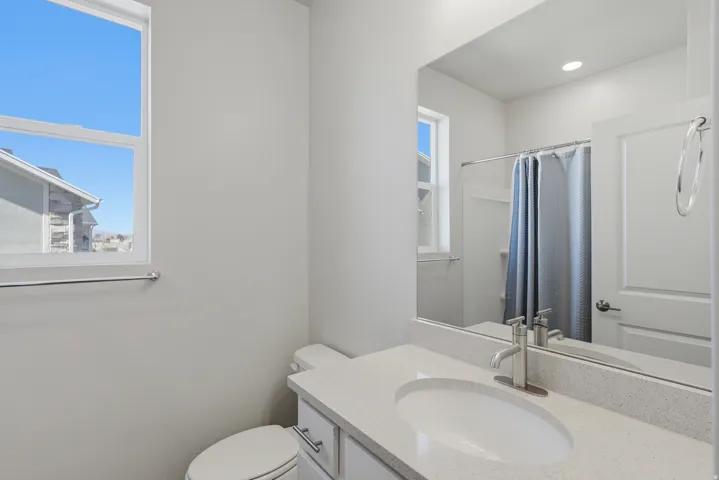 Full bath with vanity and a shower with shower curtain