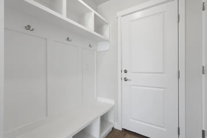Entry from the garage Mudroom featuring dark wood finished floors