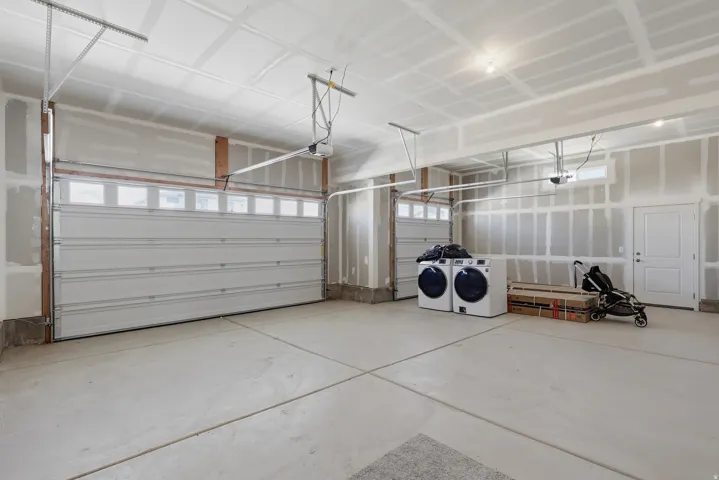 Garage featuring washer and dryer
