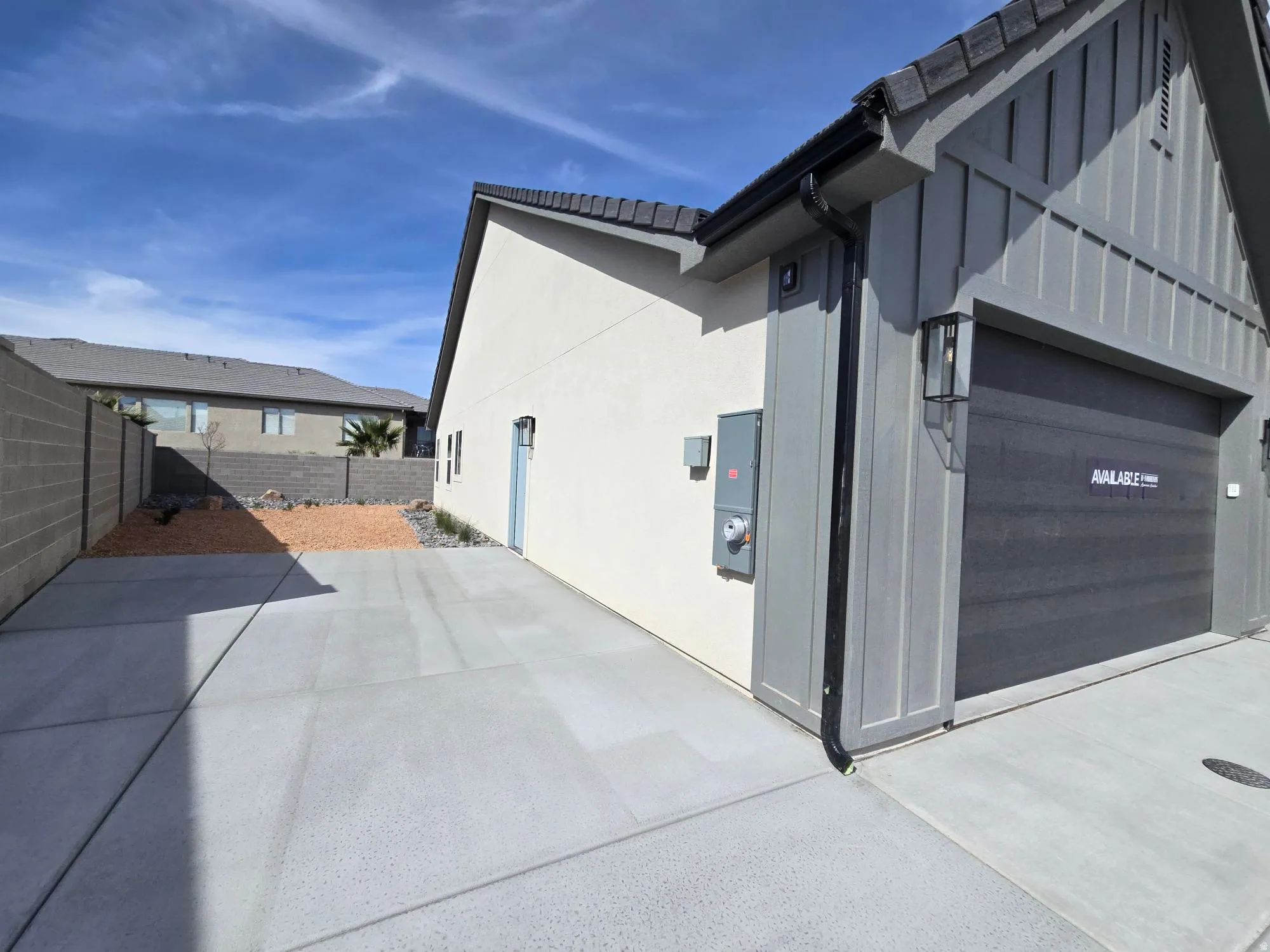 View of property exterior with a fenced backyard, stucco siding, and a tile roof