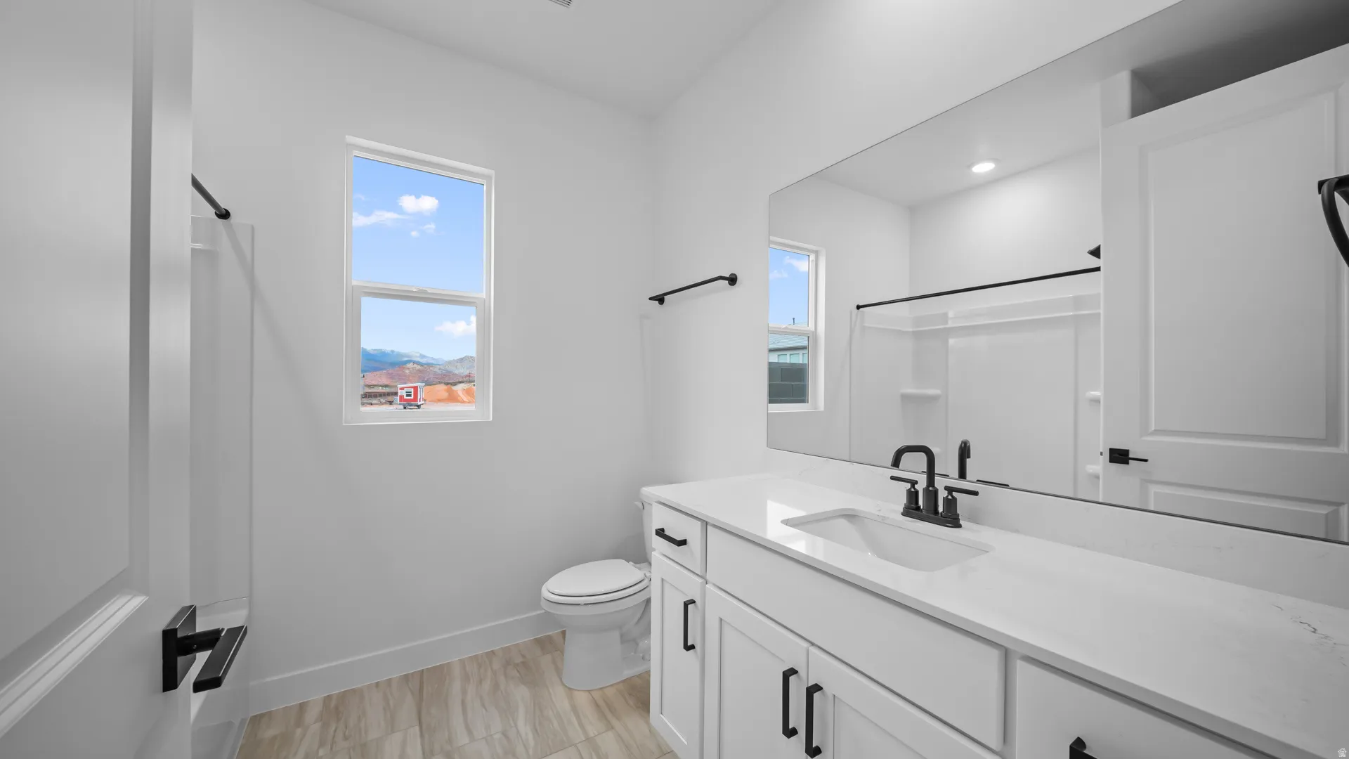 Full bathroom featuring vanity and toilet