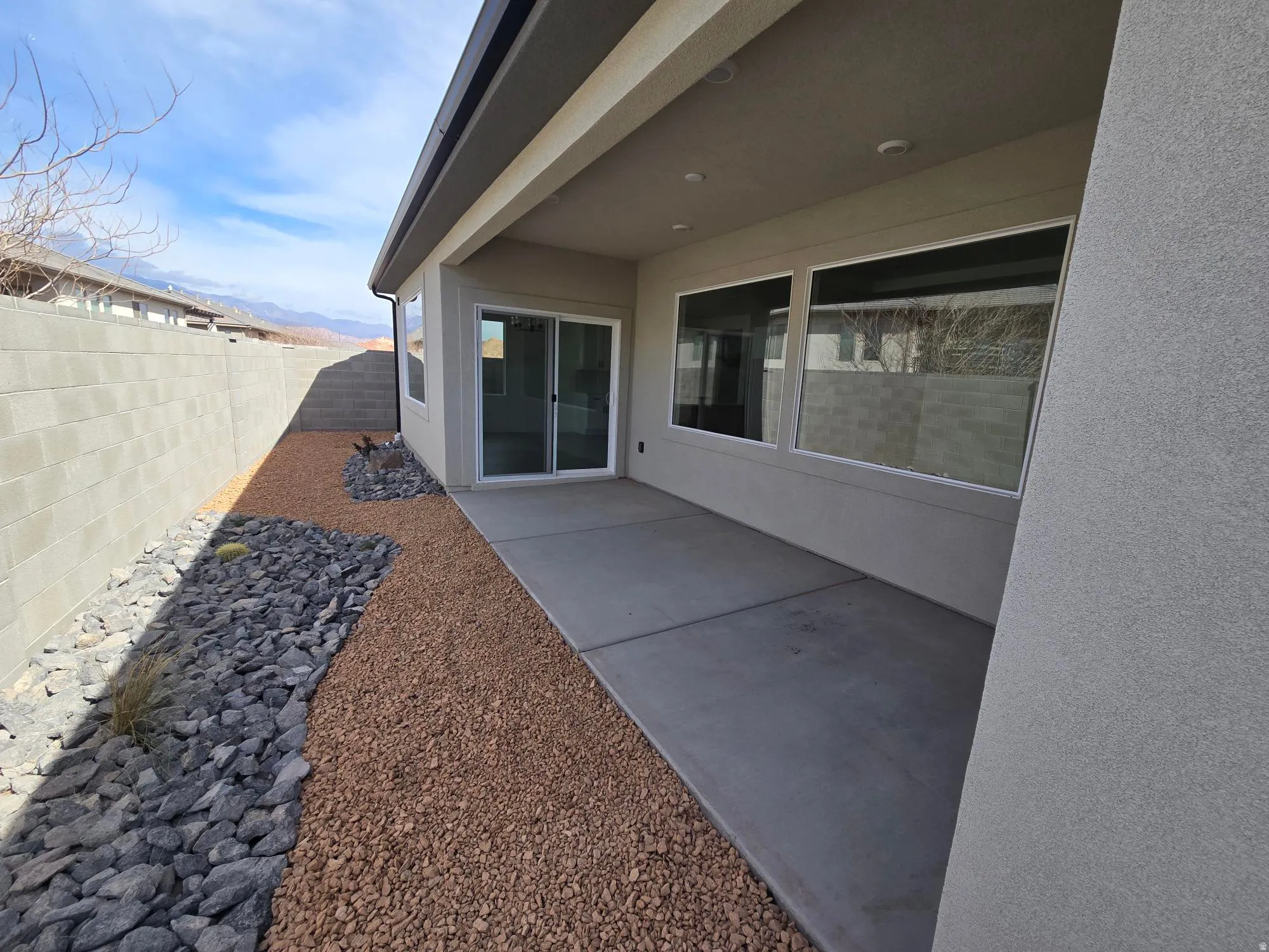 Fenced backyard with a patio and a mountain view