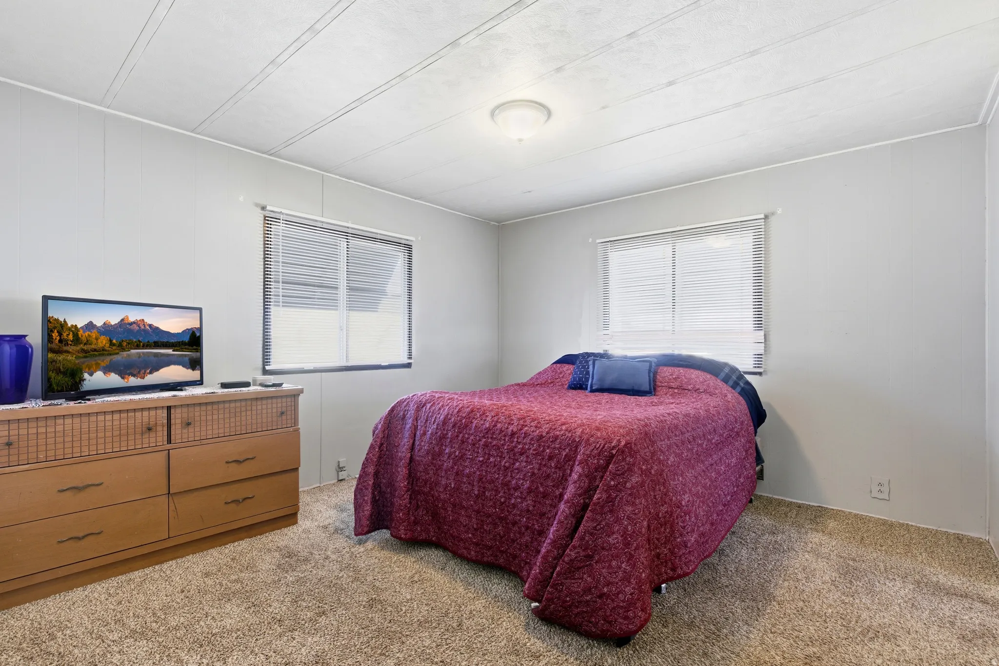 Bedroom with light colored carpet