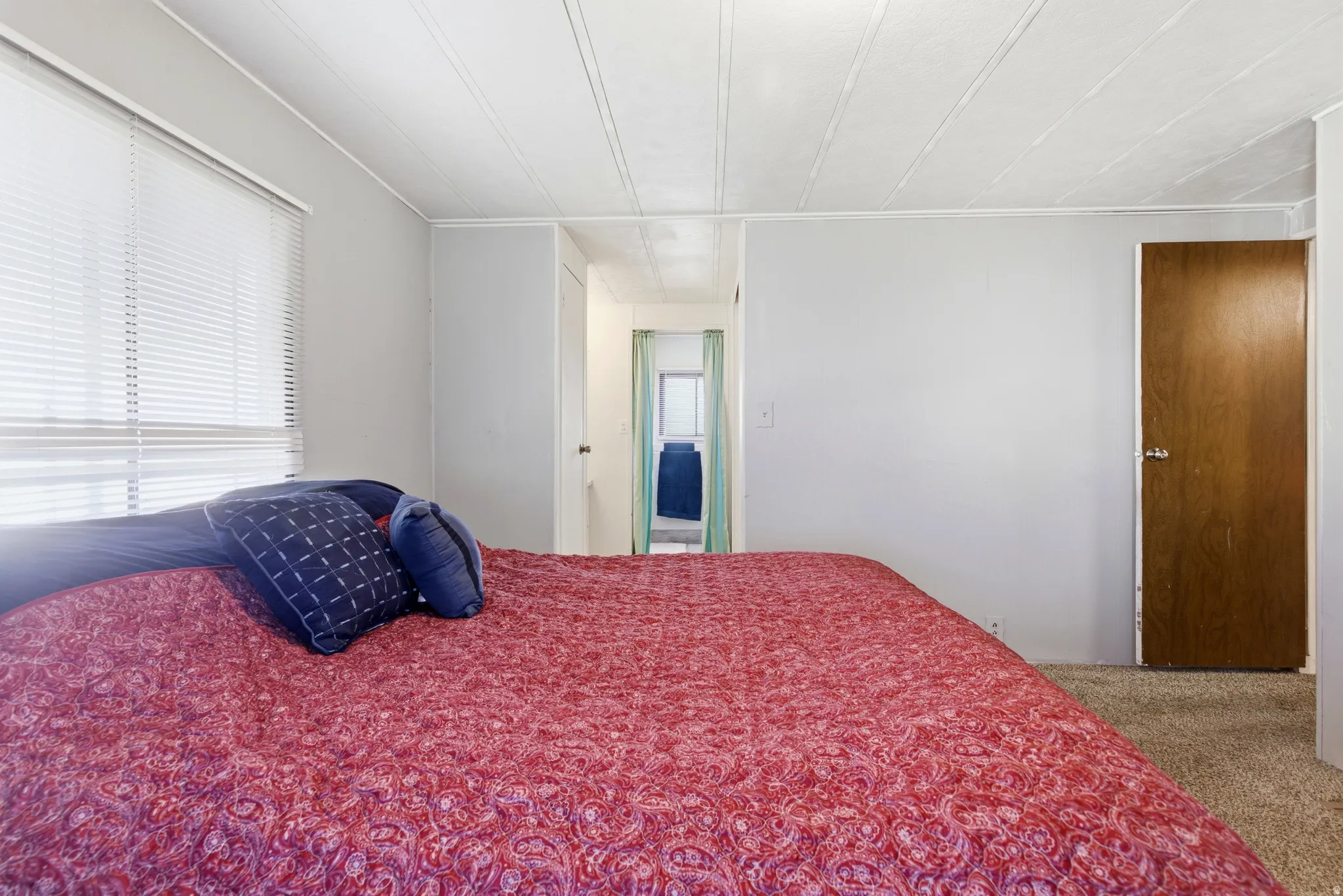 Bedroom with carpet and multiple windows