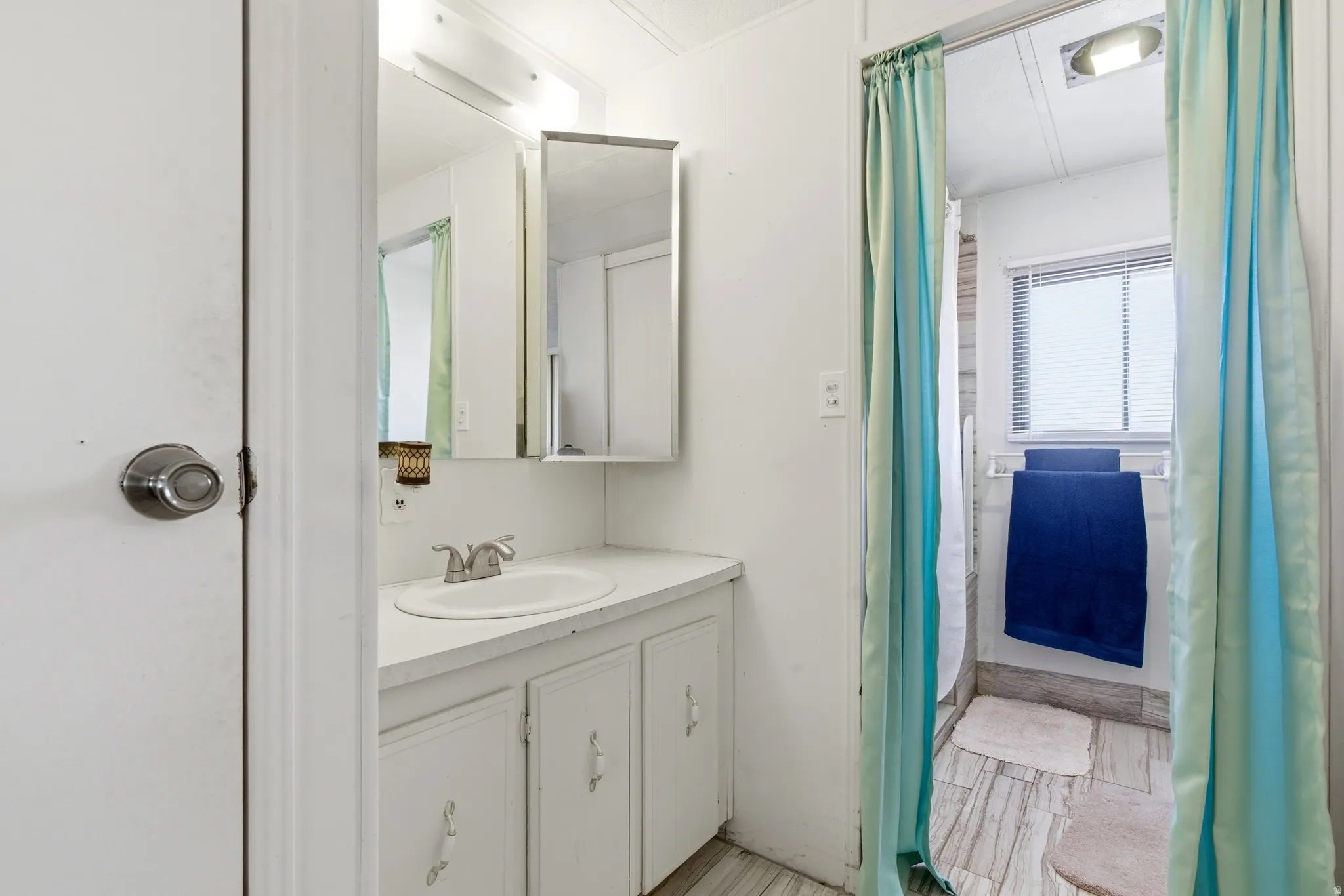 Bathroom featuring vanity and a shower with curtain