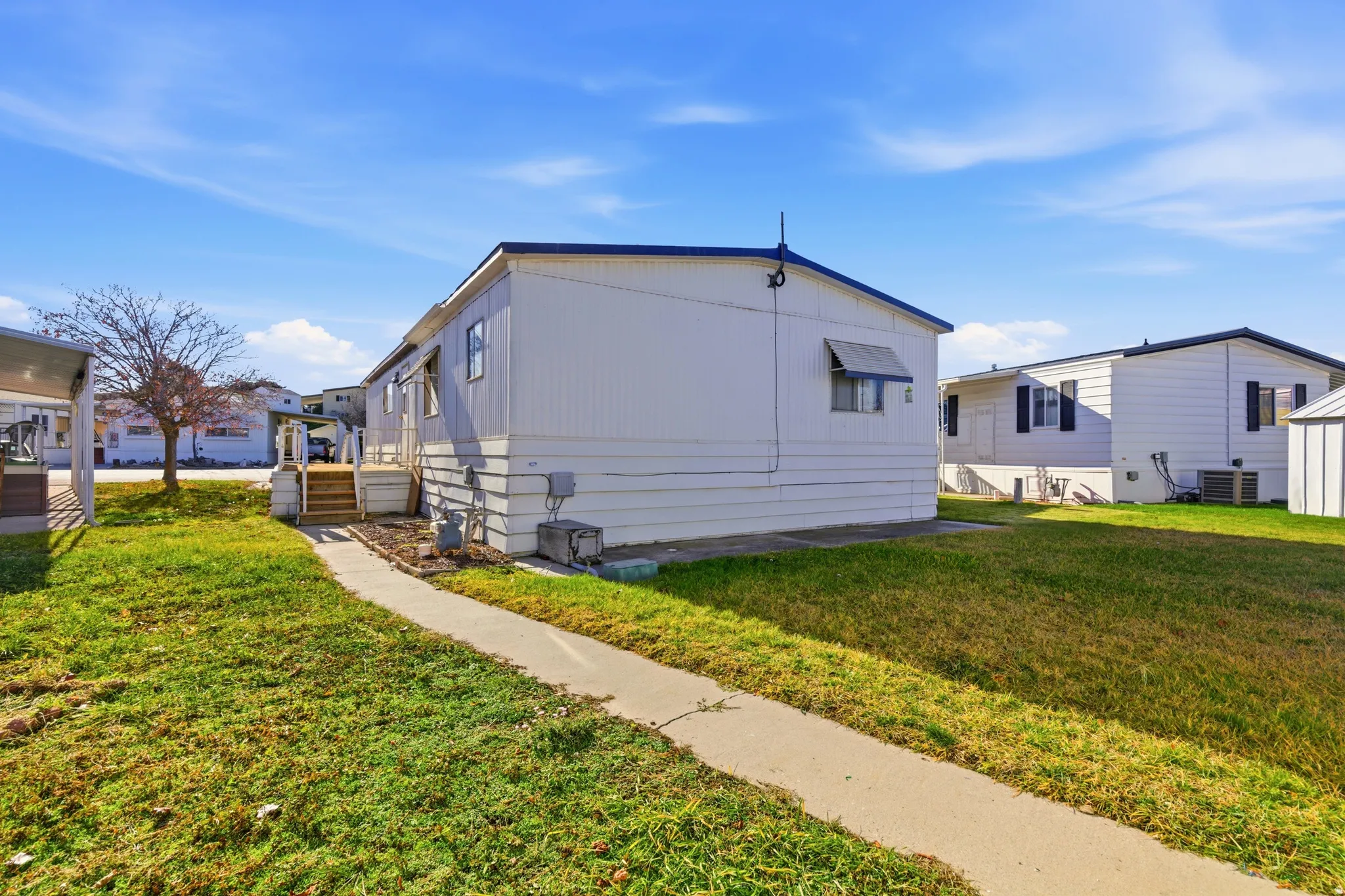 View of side of property featuring a yard