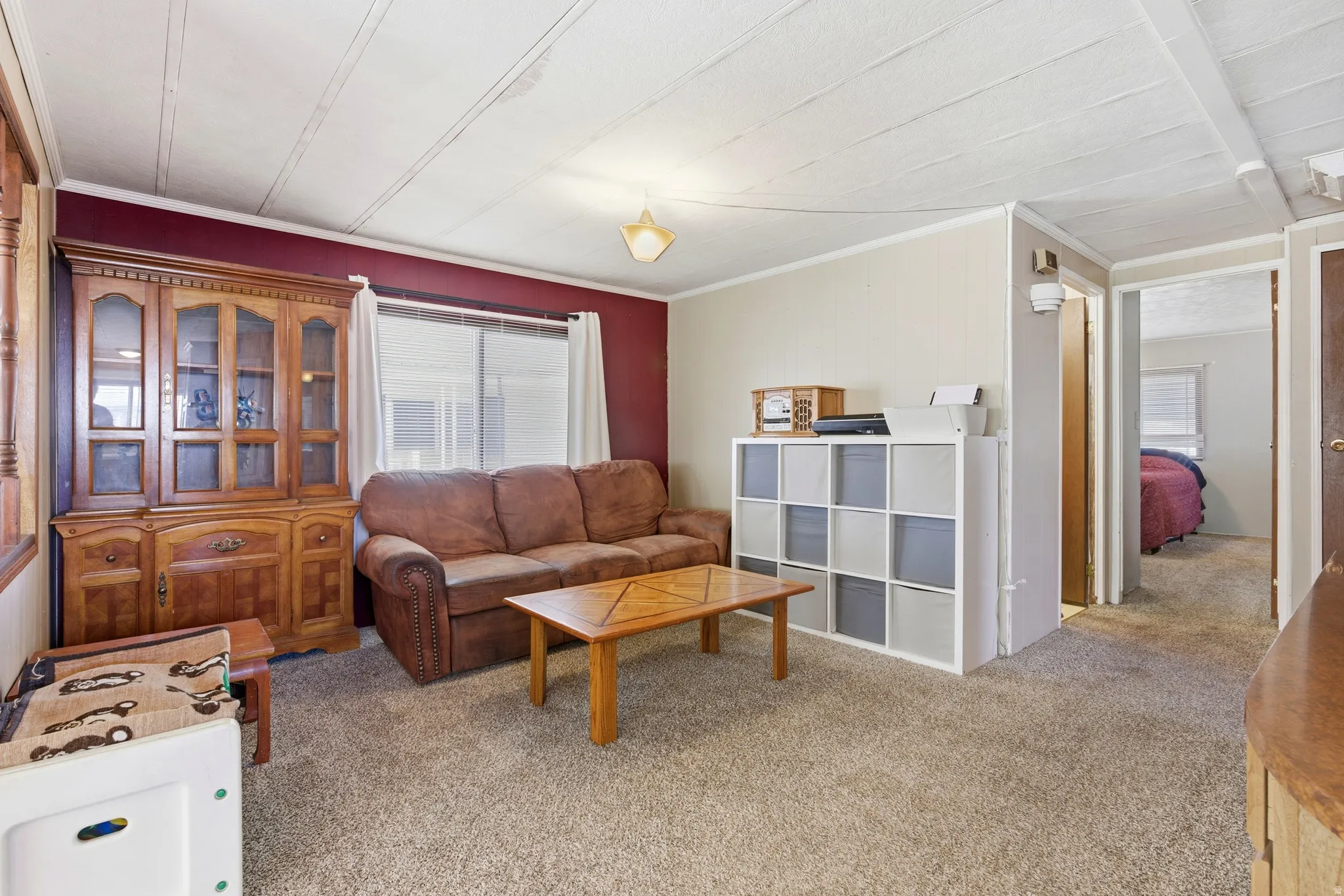 Living room with light carpet and crown molding
