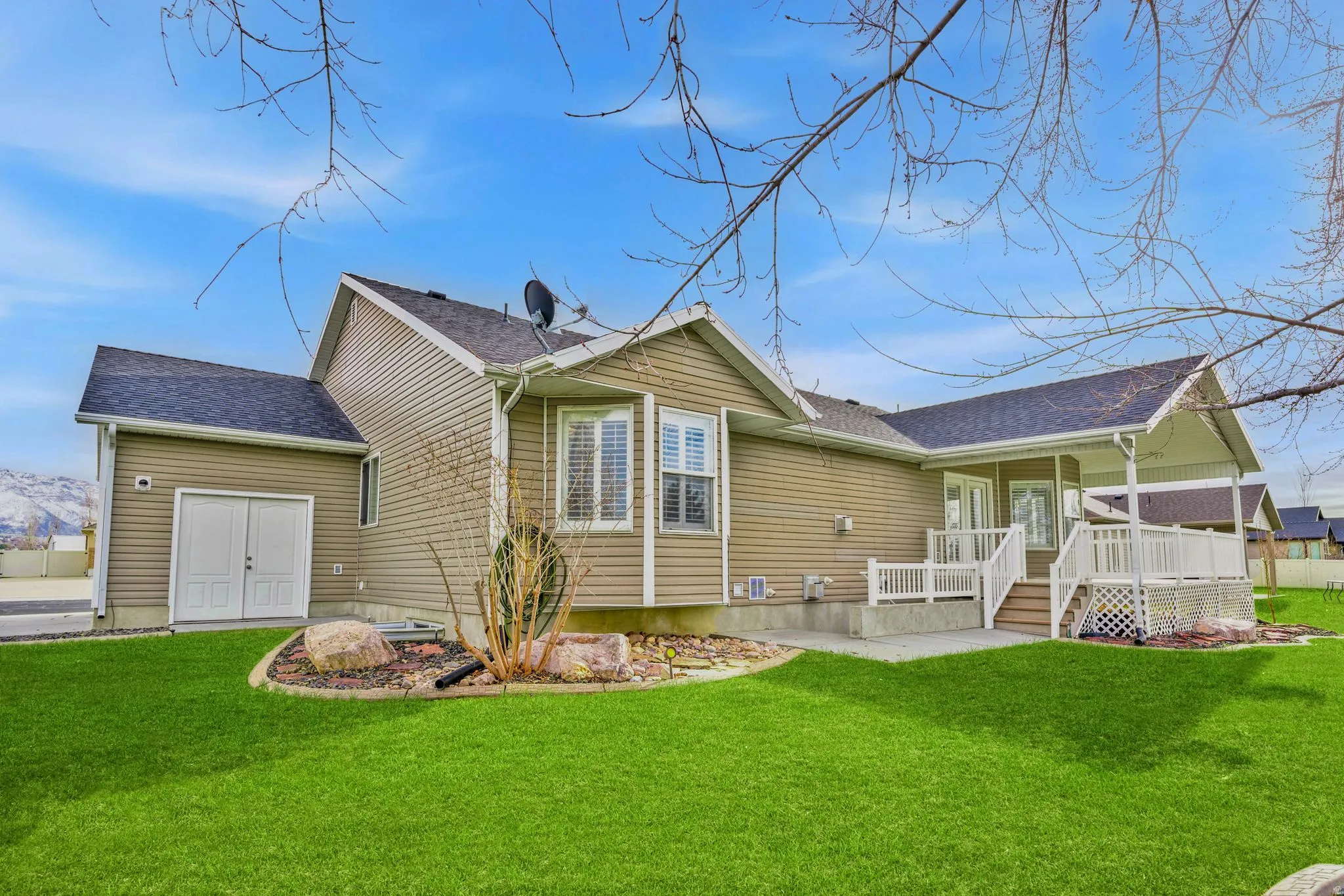 Back of property featuring a yard and roof with shingles