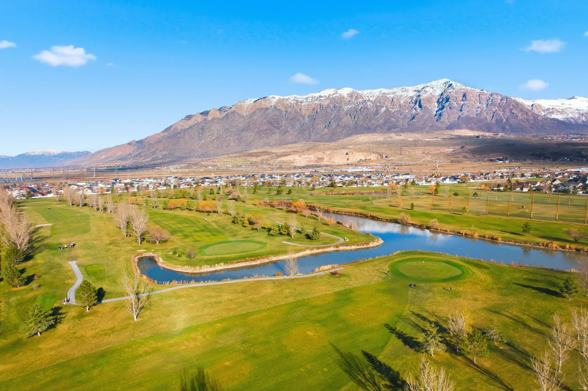 Aerial view of property's location with a water and mountain view and a golf course