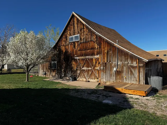 View of barn with a lawn