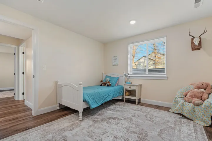 Bedroom featuring wood finished floors and baseboards