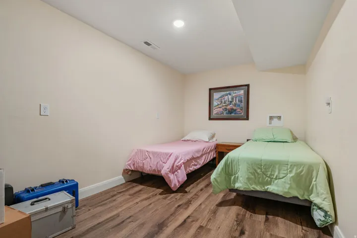 Storage room/bonus space with wood finished floors and recessed lighting