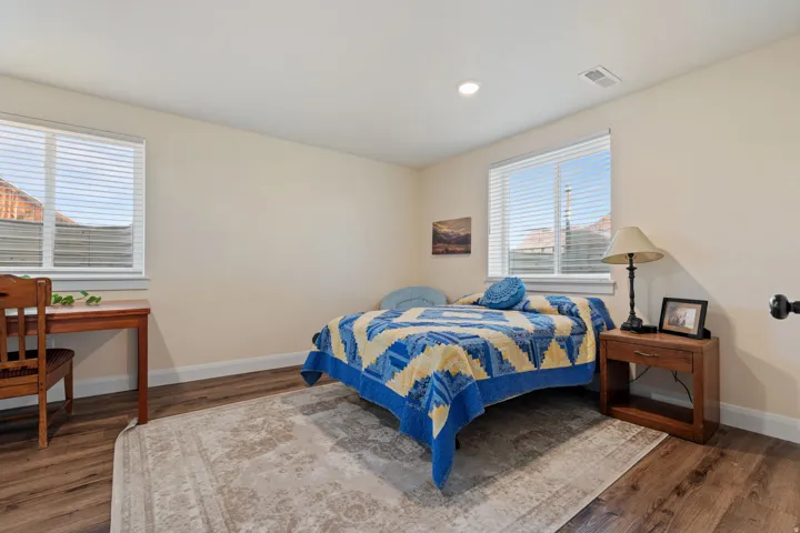 Bedroom with dark wood-type flooring and recessed lighting