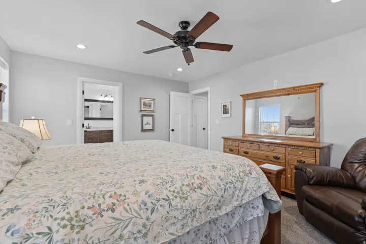 Bedroom featuring dark colored carpet, a ceiling fan, recessed lighting, and ensuite bath