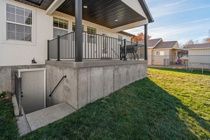 View of patio and door to basement entrance