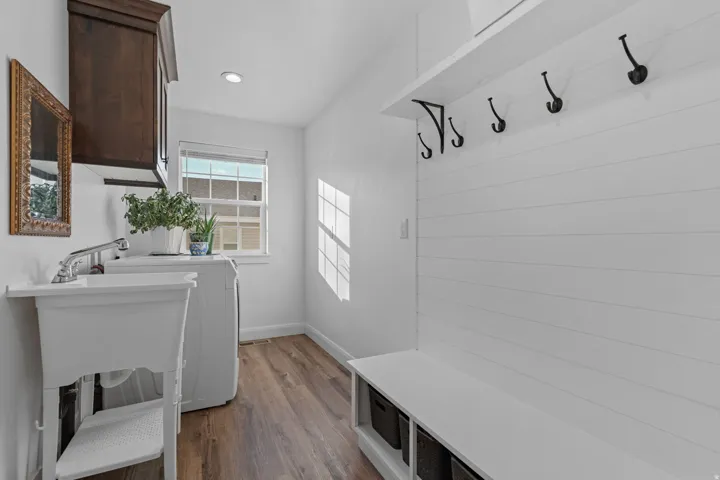 Mudroom featuring dark wood-type flooring and washer / dryer
