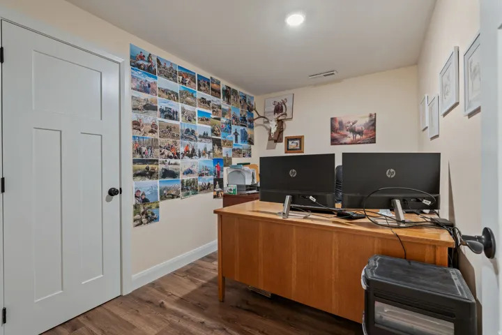 Home office featuring dark wood-style floors