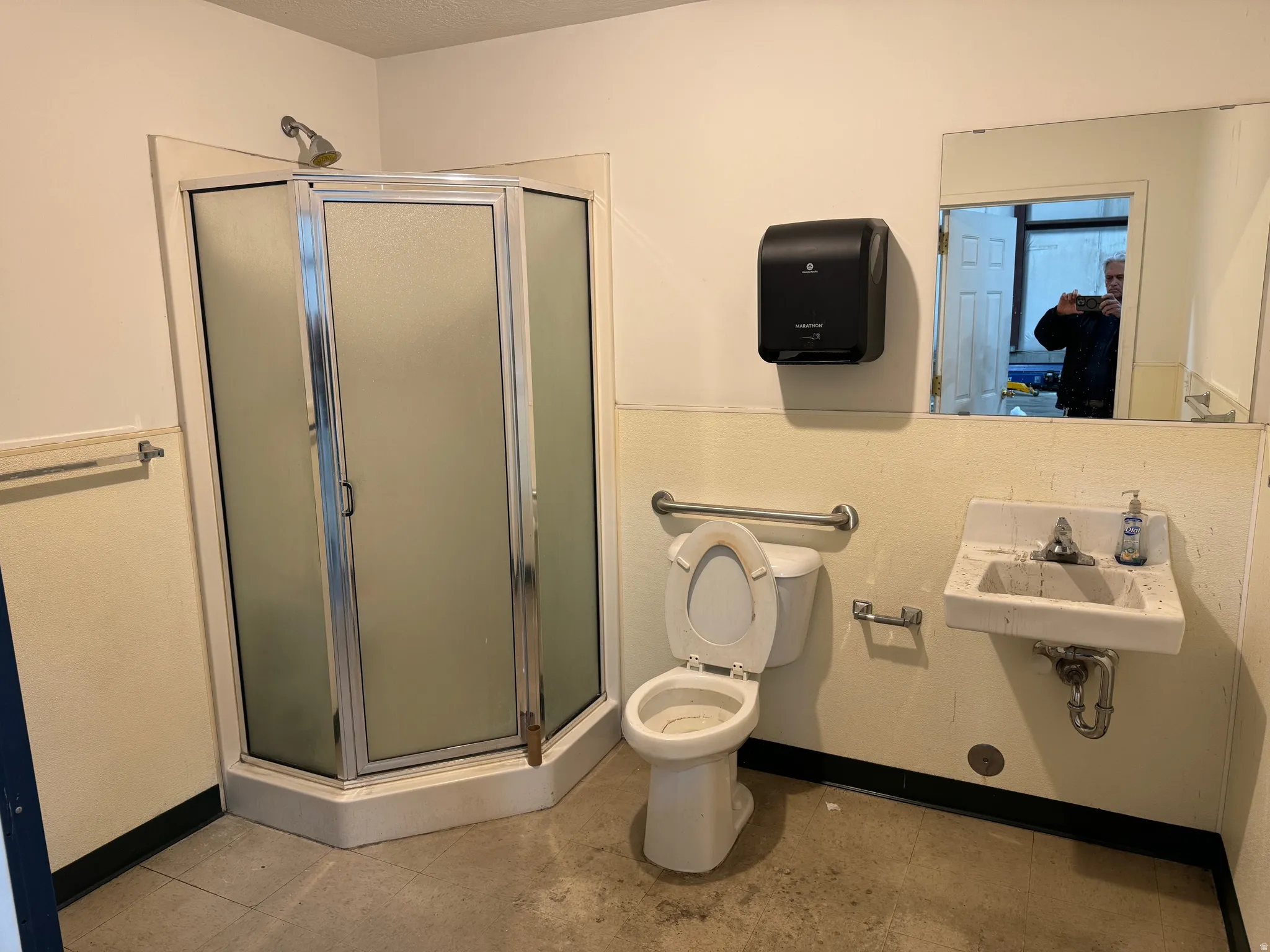 Bathroom with a shower stall and toilet