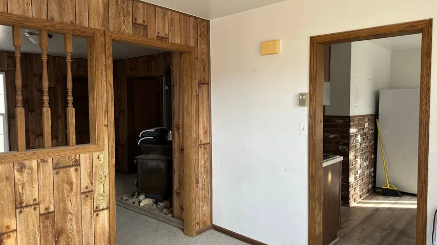 Hall with wood walls and baseboards