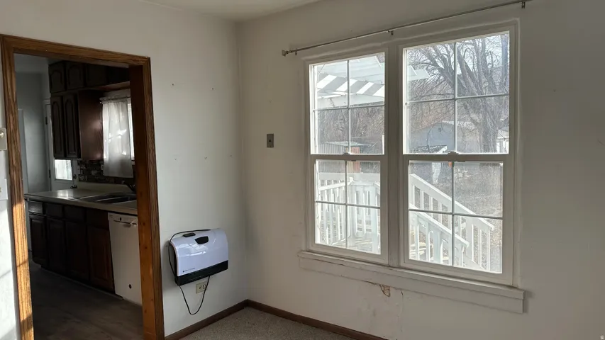 Doorway featuring a sink and baseboards