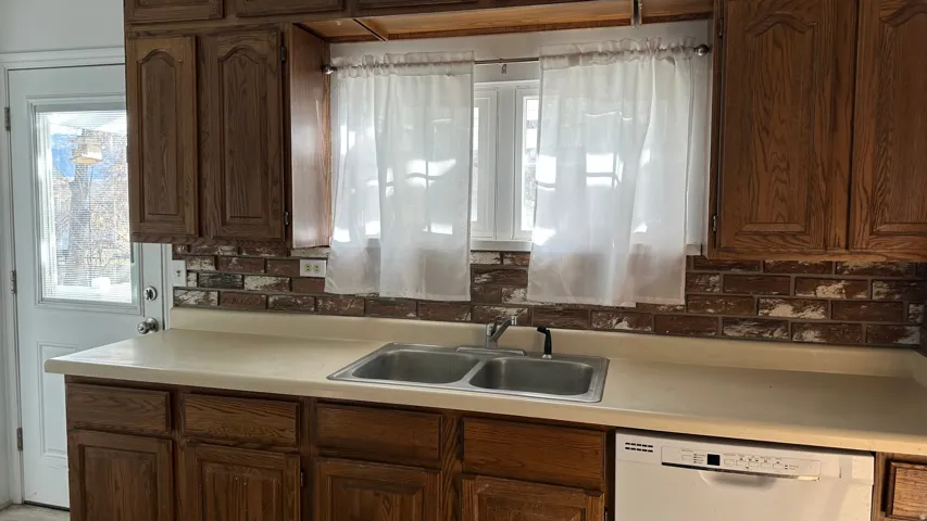Kitchen with light countertops and dishwasher