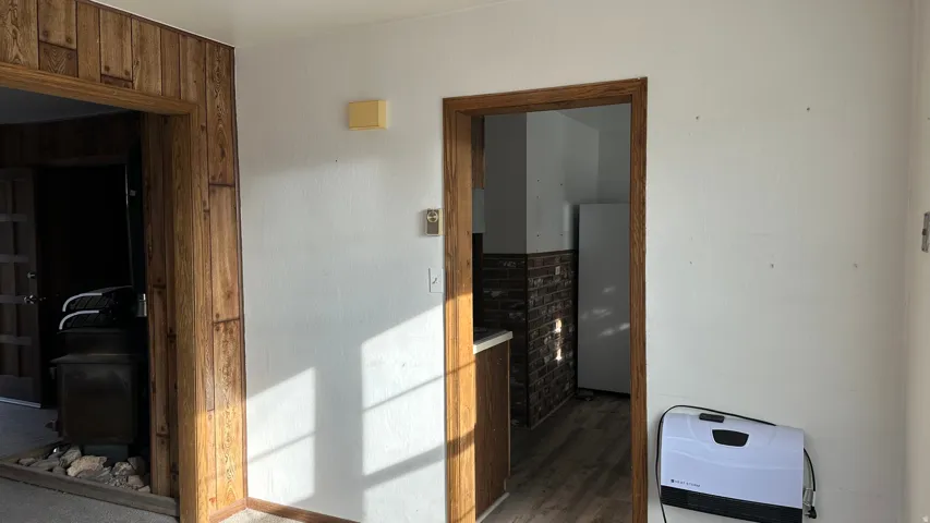 Hallway featuring dark wood-style floors
