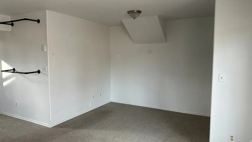 Carpeted empty room with baseboards