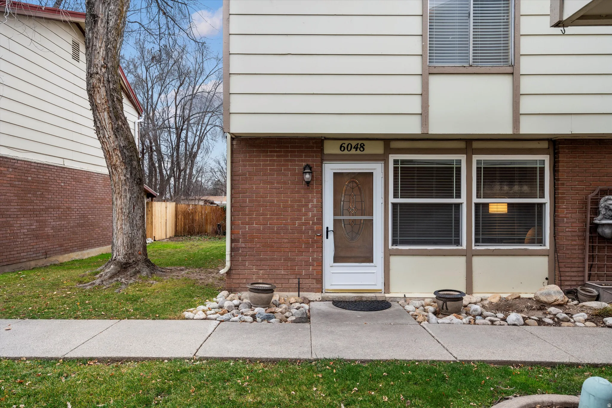 View of exterior entry featuring brick siding