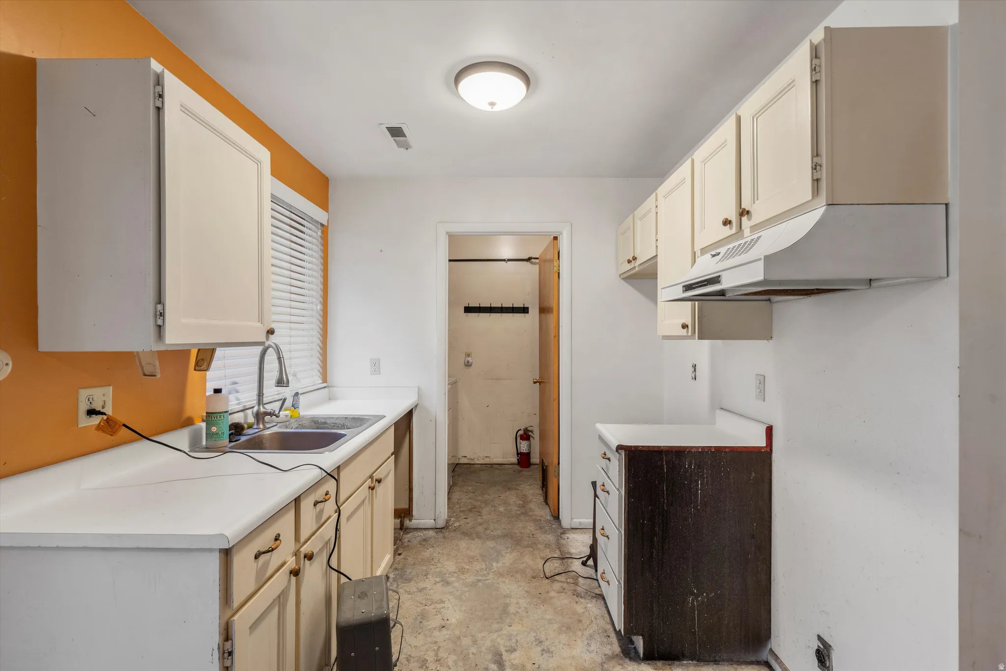 Kitchen featuring light countertops and under cabinet range hood