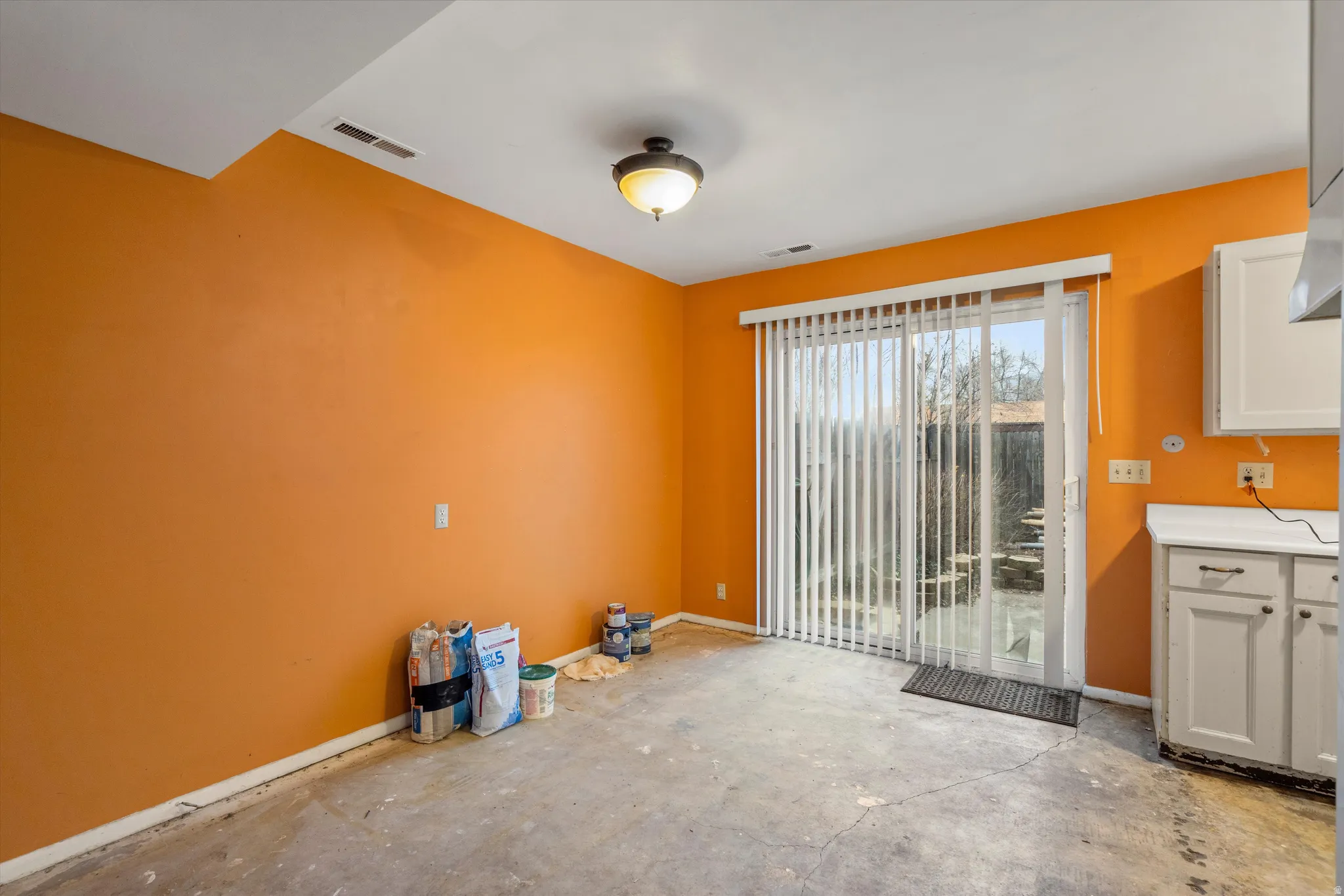 Unfurnished dining area with baseboards and unfinished concrete floors
