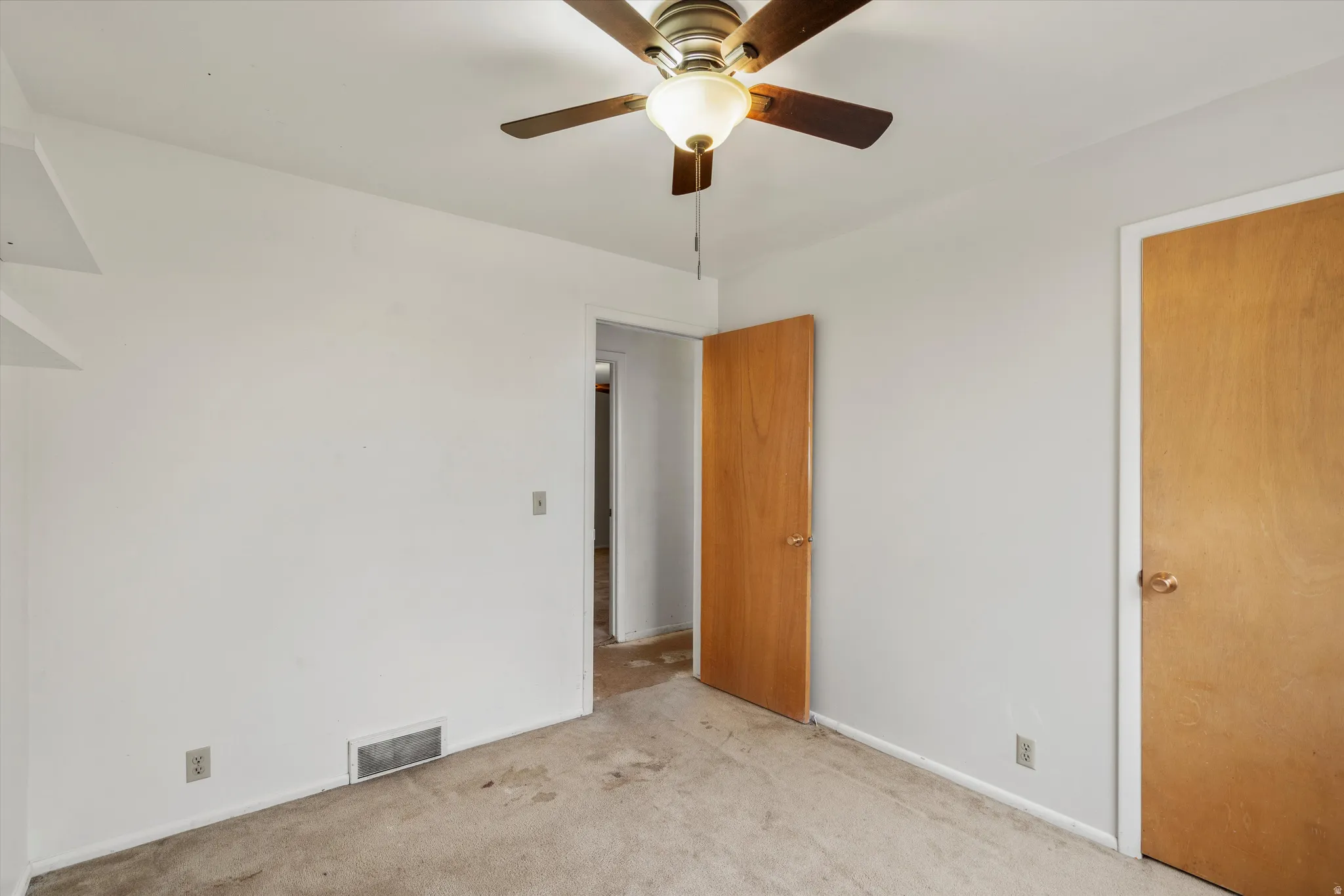 Unfurnished bedroom featuring carpet flooring and a ceiling fan