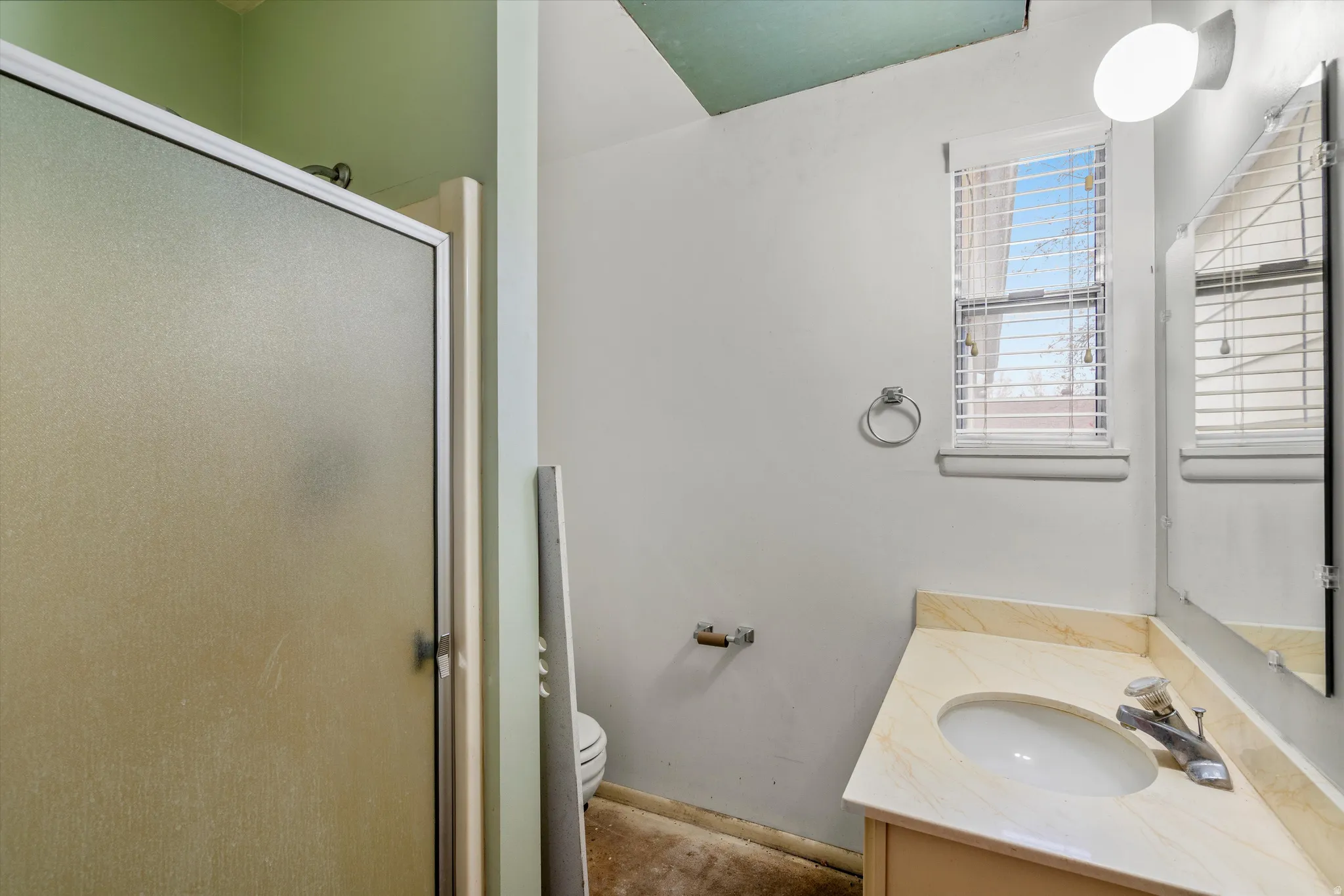 Bathroom featuring a shower stall and vanity