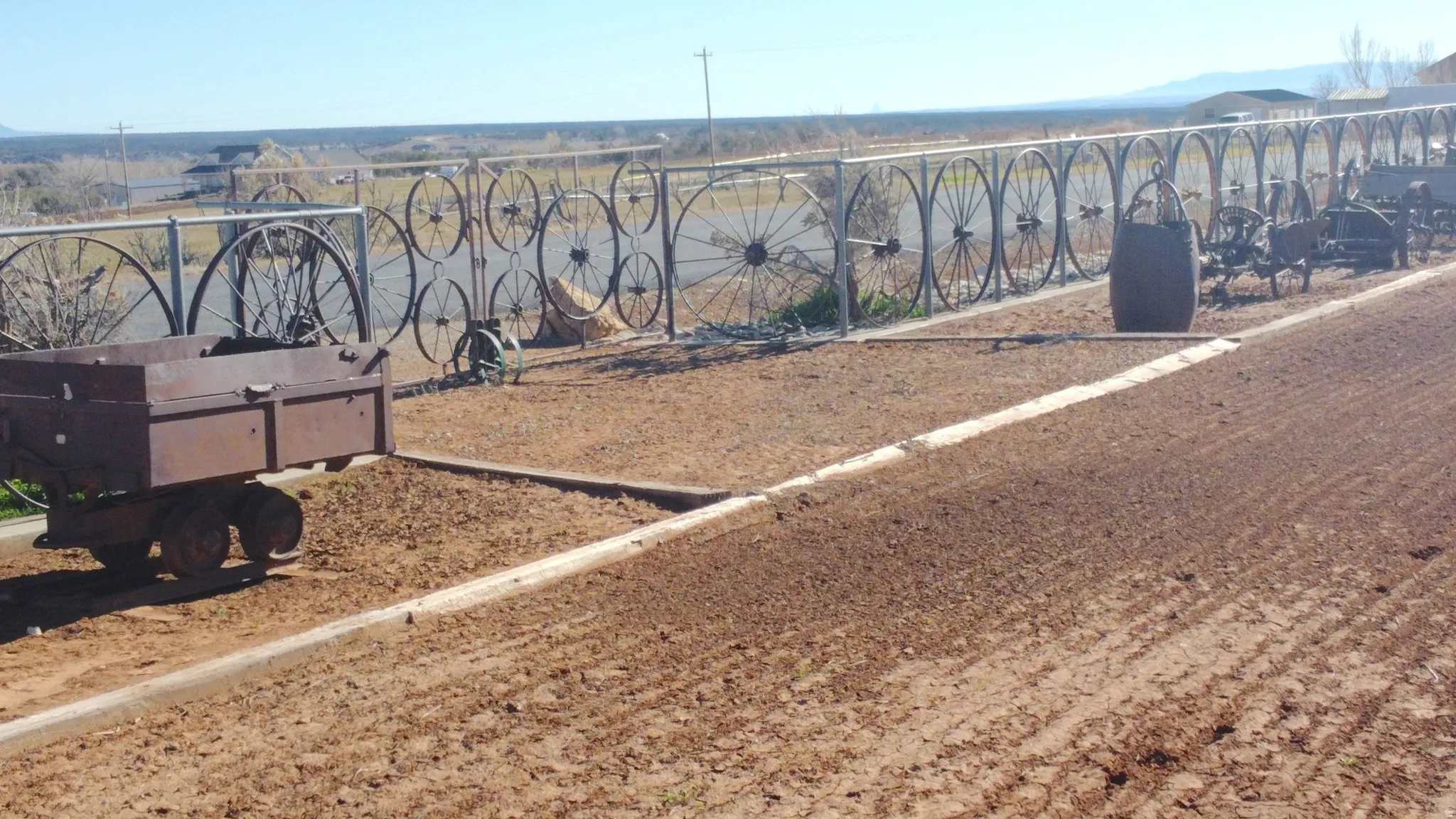 View of custom wagon wheel fence and gate