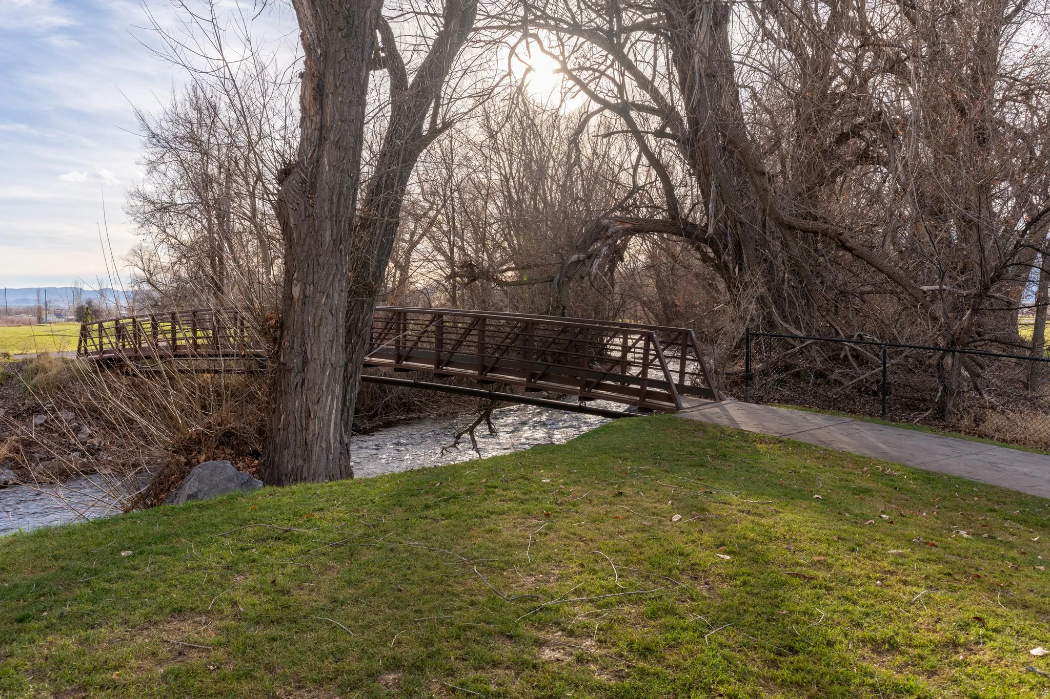 A pedestrian bridge crosses Logan River , allowing River Crossing residents easy access to the river's' edge pathway .