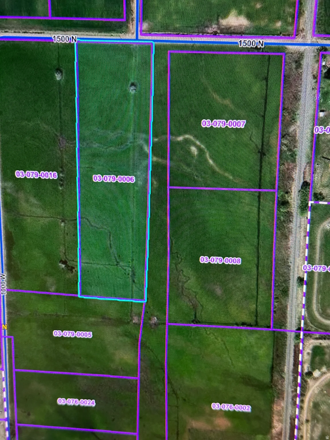 Aerial map of property and surrounding area featuring property boundaries highlighted