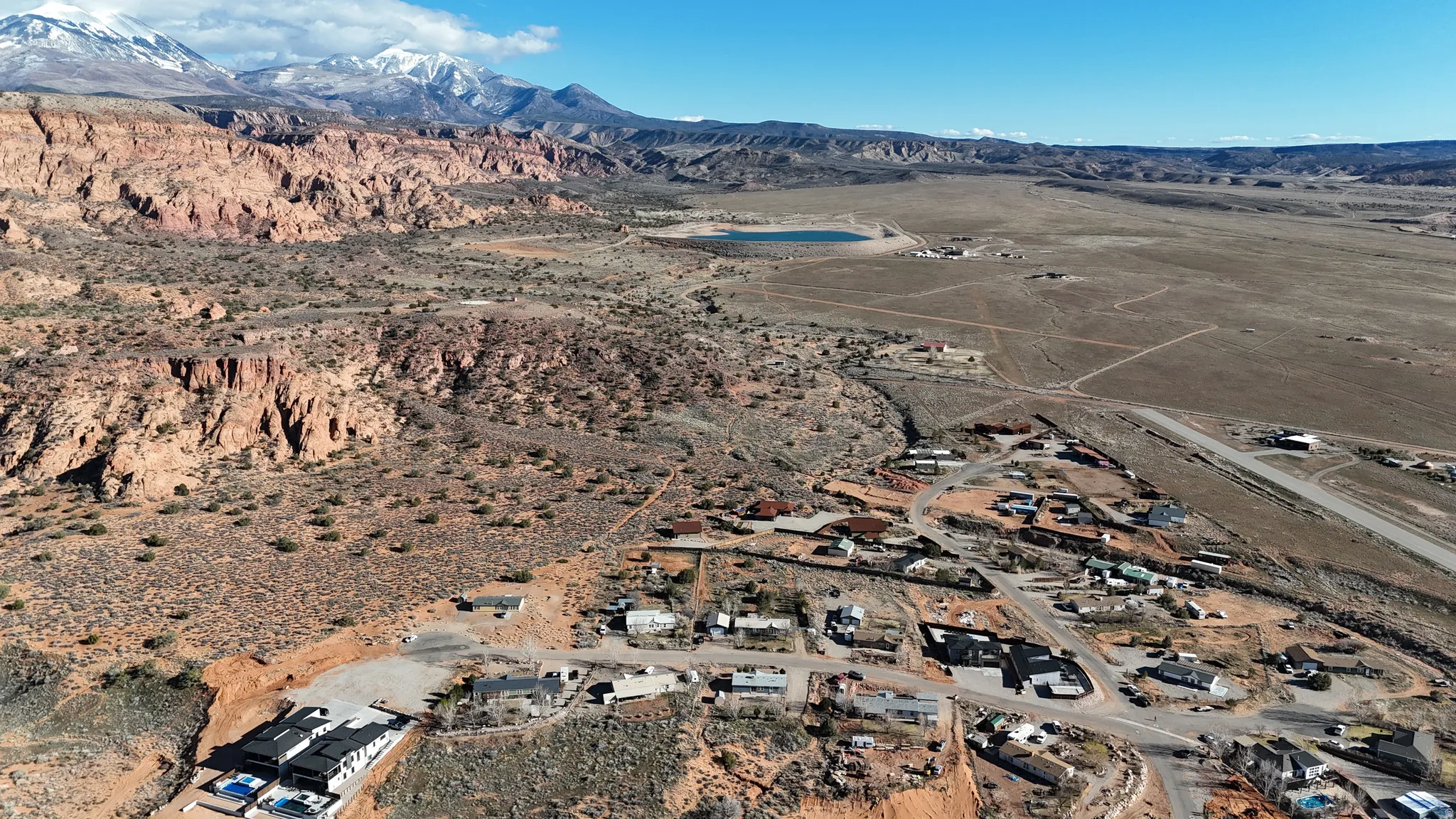 Aerial view of property's location featuring a mountainous background and rural landscape